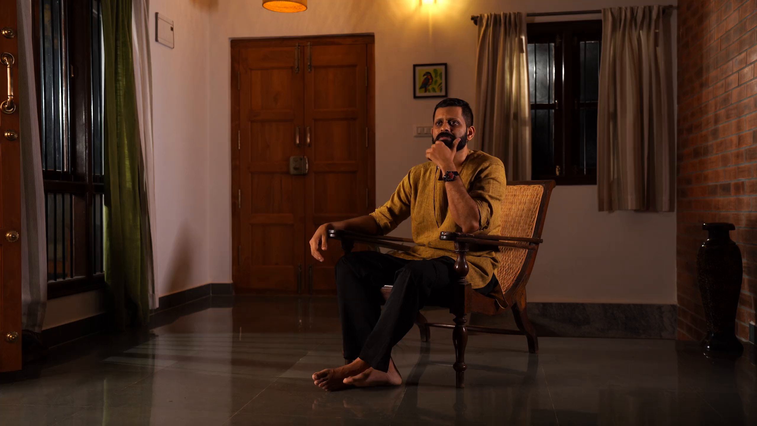 Shashank, seated, in a warm lamp-lit room.